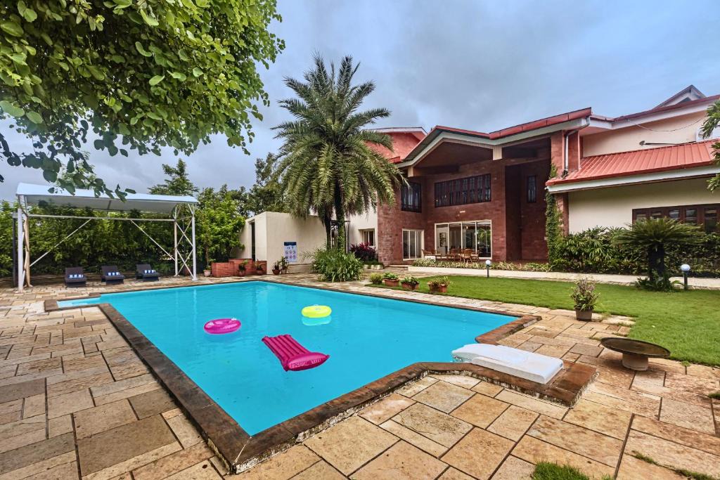Karjat Villa | SaffronStays Ananya - 4BR villa with pool, minibar & game room near river Ullas in Karjat