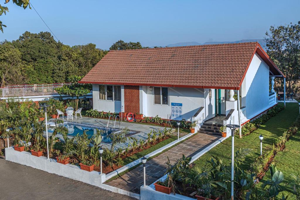 Karjat Villa | SaffronStays Mariposa Rio- 2BR Goan-style riverside pool villa with machan, garden & bonfire near Mumbai