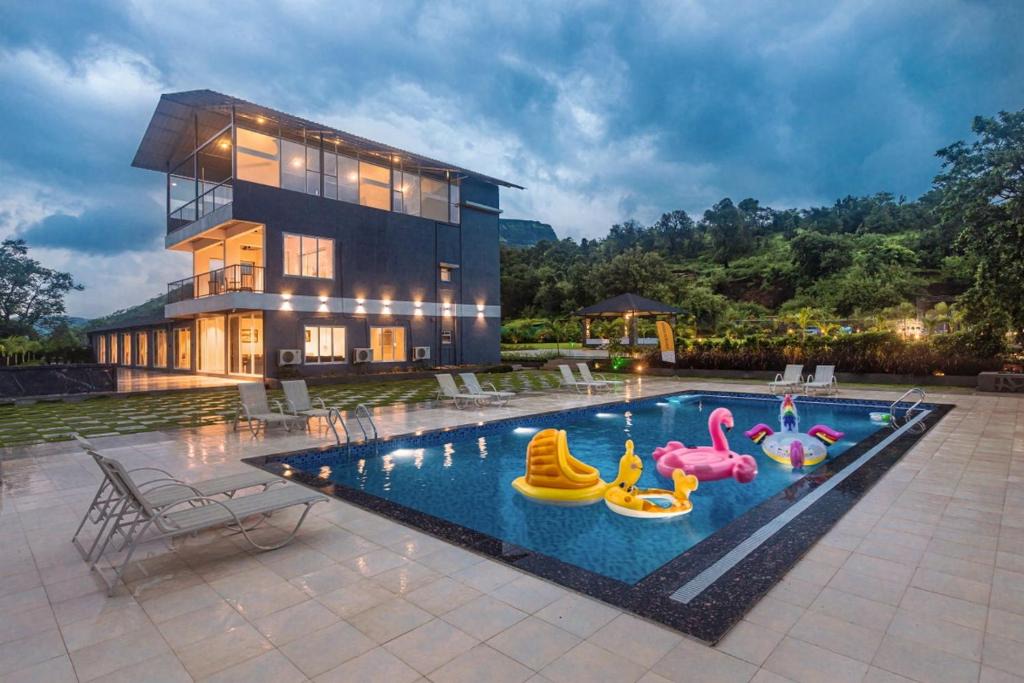 Khalapur Villa | SaffronStays Sundowner - 8BR Morbe-view villa, grand pool, outdoor bar, gazebo, TT & pool table, rain dance, award-winning