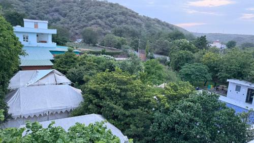 Faridabad House | Aravalli Hills golden farm, Luxury Tents & AC rooms with scenic views