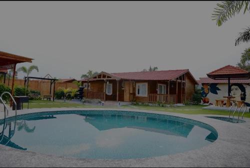 Arunam - A Royal Wooden Cottage & Pool Farmhouse