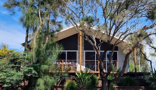 Stylish modern open‑plan beach house offering a warm, welcoming, home‑like vibe.